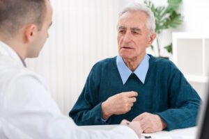 Elderly man discussing vision correction with an Ophthalmologist 